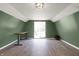 Bright bonus room with wood-look floors and access to the outdoors, perfect for an office or den at 7916 W 275 N, Boggstown, IN 46110