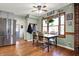 Bright dining area features a window, wood floors, a ceiling fan, and a charming table with chairs at 7916 W 275 N, Boggstown, IN 46110