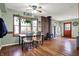Bright dining room with a view, featuring hardwood floors, a wood burning stove, and natural light at 7916 W 275 N, Boggstown, IN 46110