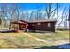 Exterior view showcasing the home's porch and spacious yard at 7916 W 275 N, Boggstown, IN 46110