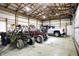 Garage featuring a high ceiling, with space for multiple vehicles and a variety of equipment at 7916 W 275 N, Boggstown, IN 46110