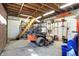 Spacious garage with wood beam ceiling and staircase leading to upper level, ideal for equipment storage at 7916 W 275 N, Boggstown, IN 46110