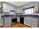 Updated kitchen featuring stainless steel appliances, tiled backsplash, and abundant cabinet storage at 7916 W 275 N, Boggstown, IN 46110