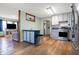 Spacious kitchen features an island, stainless steel appliances, and flows into a cozy living area at 7916 W 275 N, Boggstown, IN 46110