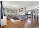 Inviting living room featuring hardwood floors, comfortable seating, and an open layout to the kitchen at 7916 W 275 N, Boggstown, IN 46110