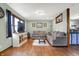 Comfortable living room featuring hardwood floors, a large window, and an open layout to the kitchen at 7916 W 275 N, Boggstown, IN 46110