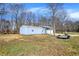 Detached outbuilding with multiple garage doors offering ample storage and workspace at 7916 W 275 N, Boggstown, IN 46110