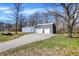 Spacious metal outbuilding featuring multiple garage doors and a gravel driveway, ideal for storage and projects at 7916 W 275 N, Boggstown, IN 46110
