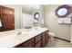 Well-lit bathroom featuring dual sinks, a large mirror, and a combination tub and shower at 7984 S Deer Lake Dr, Nineveh, IN 46164
