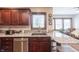 Close-up of the kitchen sink and counters with stainless dishwasher and wood cabinets at 7984 S Deer Lake Dr, Nineveh, IN 46164