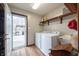 Well-lit laundry room area with appliances and access to deck at 7984 S Deer Lake Dr, Nineveh, IN 46164