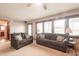 Bright living room featuring large windows, neutral carpeting, and comfortable seating arrangements at 7984 S Deer Lake Dr, Nineveh, IN 46164