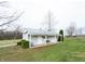 Charming outbuilding featuring a covered porch with a swing, situated on a spacious green lot at 7984 S Deer Lake Dr, Nineveh, IN 46164