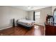 Bedroom with hardwood floors, ceiling fan, and a dresser in need of decluttering at 946 Peppermill Run, Greenwood, IN 46143