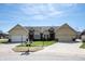 Charming townhome showcasing well-manicured lawn and attached garages, complete with inviting curb appeal at 946 Peppermill Run, Greenwood, IN 46143