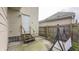 Backyard featuring a white door, concrete patio, and wooden fence with mature trees at 952 E 34Th St, Indianapolis, IN 46205