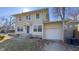 Two-story home featuring a bright blue front door, well-maintained siding, and an attached one-car garage at 952 E 34Th St, Indianapolis, IN 46205