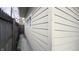Exterior view showing the side of the house with siding and a glimpse of the fenced yard at 952 E 34Th St, Indianapolis, IN 46205