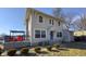 Charming two-story home with a front deck, blue door, and manicured landscaping at 952 E 34Th St, Indianapolis, IN 46205