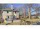 View of side exterior and rear deck of a charming home with a yard awaiting Spring bloom at 952 E 34Th St, Indianapolis, IN 46205