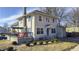 Charming two-story home featuring a cozy front porch, a well-maintained yard, and neutral-colored siding at 952 E 34Th St, Indianapolis, IN 46205