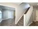 Bright hallway features stairs with white railing and a view into the living room at 952 E 34Th St, Indianapolis, IN 46205