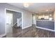 Open-concept living room featuring wood-look flooring, neutral-colored walls, and an open view to the kitchen at 952 E 34Th St, Indianapolis, IN 46205