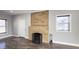 Living room with a brick fireplace, hardwood floors, and modern recessed lighting at 952 E 34Th St, Indianapolis, IN 46205