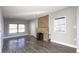 Spacious living room with wood floors, brick fireplace, and ample natural light at 952 E 34Th St, Indianapolis, IN 46205
