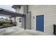 Side exterior of a home, featuring a blue side entrance door and large deck for entertaining at 952 E 34Th St, Indianapolis, IN 46205