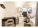 Bright bathroom with white cabinets, a dark vanity, and a black-and-white patterned floor at 9619 E Southport Rd, Indianapolis, IN 46259