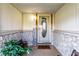 Charming entryway with stone walls, welcoming decor, bench seating, and a glass-paneled front door at 9619 E Southport Rd, Indianapolis, IN 46259