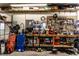 Garage workspace featuring a pegboard, shelving, tools, and equipment, ideal for DIY projects and organization at 9619 E Southport Rd, Indianapolis, IN 46259