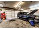 Well-lit garage with a SUV, workbench, and various tools and equipment, perfect for car maintenance and projects at 9619 E Southport Rd, Indianapolis, IN 46259