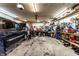 Spacious garage with multiple vehicles, tools, and equipment, providing ample space for projects and storage at 9619 E Southport Rd, Indianapolis, IN 46259