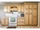 Well-lit kitchen with a white oven, custom cabinetry, and plenty of counter space for meal preparation at 9619 E Southport Rd, Indianapolis, IN 46259