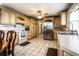 Spacious kitchen with stainless steel refrigerator, ample cabinetry, and a combination of tile flooring at 9619 E Southport Rd, Indianapolis, IN 46259
