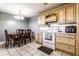 Eat-in kitchen with a dining table and chairs adjacent to the stove with overhead microwave oven at 9619 E Southport Rd, Indianapolis, IN 46259