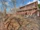 A two-story brick house with multiple decks overlooking a leaf-covered backyard and a wooded area, providing privacy at 108 Parkridge Dr, Danville, IN 46122