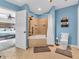 Bathroom featuring blue walls, tile shower/tub, and neutral tile flooring at 108 Parkridge Dr, Danville, IN 46122