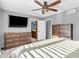 Bright bedroom with neutral grey walls, carpeted floors, ceiling fan, and wood furniture at 108 Parkridge Dr, Danville, IN 46122