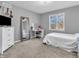 Neutral bedroom with large window, white desk, and full-length mirror at 108 Parkridge Dr, Danville, IN 46122