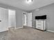 A neutral bedroom with grey walls, carpeted floors, and white dresser with drawers at 108 Parkridge Dr, Danville, IN 46122