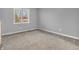 A simple bedroom featuring light grey walls, carpeted floors, and a window with blinds at 108 Parkridge Dr, Danville, IN 46122