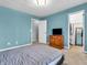 A cozy bedroom features blue walls, carpeted floors, and closet with a mirror at 108 Parkridge Dr, Danville, IN 46122