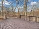 Large wood deck with brown railings, ideal for enjoying the outdoor space and views of the surrounding trees at 108 Parkridge Dr, Danville, IN 46122