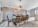 Elegant dining area features a whitewashed brick wall, contemporary lighting, and ample seating for gatherings at 108 Parkridge Dr, Danville, IN 46122