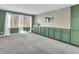 Bright dining room boasts built-in cabinets, a neutral wallpapered wall, and large windows for natural light at 108 Parkridge Dr, Danville, IN 46122
