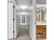 Long hallway with neutral walls and carpeting leading to bedrooms and bathroom at 108 Parkridge Dr, Danville, IN 46122