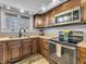 Well-lit kitchen features wood cabinets, modern appliances, and a view of the backyard at 108 Parkridge Dr, Danville, IN 46122